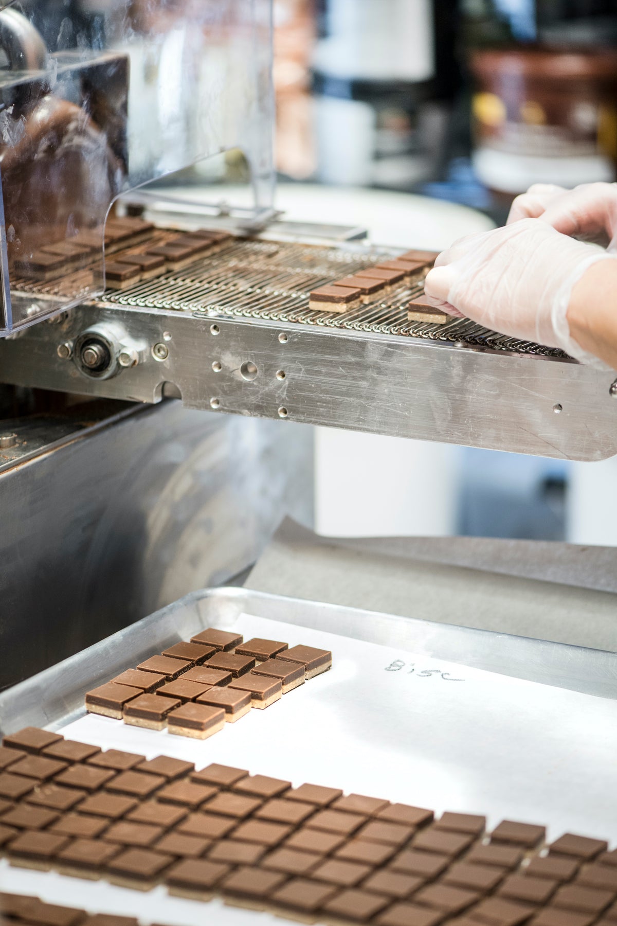 Hand-cut chocolate squares on a tray in the William Dean Chocolates kitchen